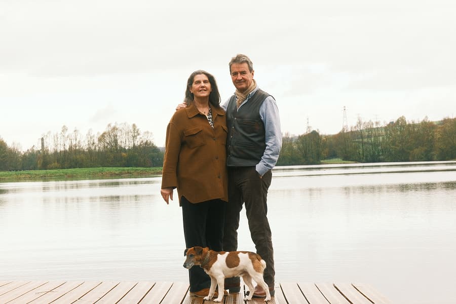 Marie-Annick and Jérôme, the owners of Lieudieu, with their dog Pepper, by one of their ponds within the estate